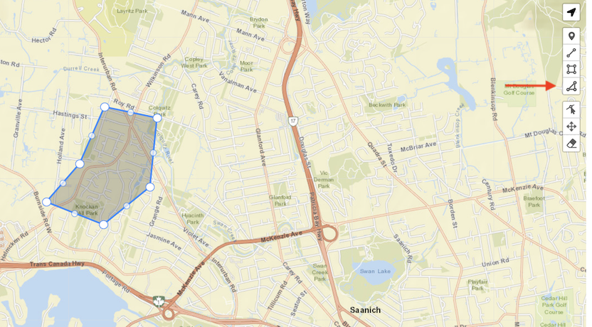 A polygon shape drawn on a map, and a red arrow pointing to the toolbar